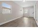 Bright living room featuring wood-look flooring and plenty of natural light from dual windows at 5111 N 30Th St, Tampa, FL 33610