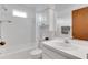 Bathroom with shower-tub combo and single sink vanity with dark brown cabinet at 5207 Moeller Ave, Sarasota, FL 34233