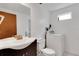 Well-lit bathroom featuring a single sink vanity, toilet, washing machine, and natural light at 5207 Moeller Ave, Sarasota, FL 34233