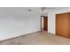 Empty bedroom with carpet and ceiling fan and access to another room at 5207 Moeller Ave, Sarasota, FL 34233
