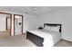 Bright bedroom with a neutral color palette, carpet flooring and ensuite bath at 5207 Moeller Ave, Sarasota, FL 34233