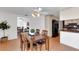 Neutral dining area with hardwood floors, kitchen access, and view into adjacent living area at 5207 Moeller Ave, Sarasota, FL 34233