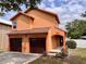Charming two-story home features an attached two-car garage, neatly kept landscaping, and a welcoming covered entryway at 5207 Moeller Ave, Sarasota, FL 34233