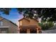 Two-story home showcasing a two-car garage, stucco exterior, and cozy architecture against a colorful sky at 5207 Moeller Ave, Sarasota, FL 34233