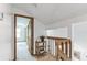 Upstairs hallway featuring a small table, banister and carpeted floor at 5207 Moeller Ave, Sarasota, FL 34233