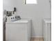 Functional laundry room featuring a washing machine and dryer with bright white walls and tile floors at 5207 Moeller Ave, Sarasota, FL 34233