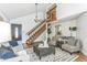 Inviting living area features high ceilings, warm wood accents, and a view of the staircase for a spacious feel at 5207 Moeller Ave, Sarasota, FL 34233