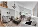 Open-concept living and dining area with high ceilings, stylish furnishings, and natural light creates an airy ambiance at 5207 Moeller Ave, Sarasota, FL 34233