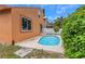 An inviting pool is set in a private yard, enhanced by lush greenery and a sunny atmosphere at 5207 Moeller Ave, Sarasota, FL 34233
