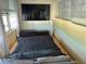 Bedroom featuring mounted TV and windows with shades at 6000 20Th N St # 138, St Petersburg, FL 33714