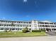 Beautiful condo building featuring balconies and well-manicured landscaping at 6000 20Th N St # 138, St Petersburg, FL 33714