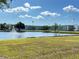 Beautiful condominium complex featuring a pristine lake with a fountain on a sunny day at 6000 20Th N St # 138, St Petersburg, FL 33714