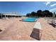 Beautiful community pool surrounded by lounge chairs and tables under a clear blue sky at 6000 20Th N St # 138, St Petersburg, FL 33714