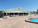 Inviting swimming pool with brick patio featuring an awning covered lounge area at 6000 20Th N St # 138, St Petersburg, FL 33714
