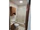 Bathroom featuring a bathtub, vanity, and wood paneled door, offering a private sanctuary at 6012 Frond Way, Apollo Beach, FL 33572