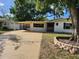 Charming single-story home with a carport and landscaped yard, offering a cozy and inviting curb appeal at 6012 Frond Way, Apollo Beach, FL 33572