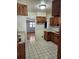 Functional kitchen with wood cabinets, white countertops, and tile flooring, ready for culinary adventures at 6012 Frond Way, Apollo Beach, FL 33572
