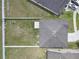An aerial view of a home with an empty grassy fenced backyard at 662 Petal Mist Ln, Brooksville, FL 34604