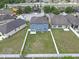 Aerial view of a fully fenced backyard with green space and a playset at 662 Petal Mist Ln, Brooksville, FL 34604