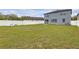 Expansive backyard featuring green grass, a white fence and playset at 662 Petal Mist Ln, Brooksville, FL 34604