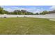 Spacious backyard with lush green grass and a white fence at 662 Petal Mist Ln, Brooksville, FL 34604