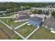 Aerial view of a spacious backyard with a white fence, green grass, trampoline, and play set at 662 Petal Mist Ln, Brooksville, FL 34604
