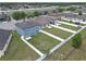 Aerial view of a spacious backyard featuring a white fence, lush lawn, and play equipment at 662 Petal Mist Ln, Brooksville, FL 34604