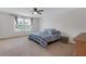 Bedroom with a ceiling fan, a bed with striped bedspread and two windows at 662 Petal Mist Ln, Brooksville, FL 34604