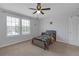 Bedroom with light walls, ceiling fan, and natural light from a large window at 662 Petal Mist Ln, Brooksville, FL 34604