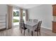 A bright dining area features glass doors providing a picturesque view of the backyard at 662 Petal Mist Ln, Brooksville, FL 34604