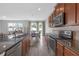 Featuring stainless appliances and breakfast bar, this kitchen seamlessly flows into the dining and living area for easy entertaining at 662 Petal Mist Ln, Brooksville, FL 34604
