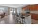 Open-concept kitchen with stainless steel appliances, breakfast bar seating, and access to the backyard through sliding glass doors at 662 Petal Mist Ln, Brooksville, FL 34604