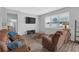 A cozy living room featuring a large window, plush seating, and stylish decor at 662 Petal Mist Ln, Brooksville, FL 34604