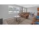 Bright and airy living room with wood-look floors, plush seating, and a view of the backyard at 662 Petal Mist Ln, Brooksville, FL 34604
