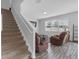 A cozy living room featuring stairs, a large window, plush seating, and stylish decor at 662 Petal Mist Ln, Brooksville, FL 34604