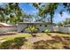 Rear exterior view shows a backyard with privacy fence and lush landscaping at 6703 N Boulevard, Tampa, FL 33604