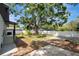 Spacious backyard with large tree, concrete pads, and a full privacy fence at 6703 N Boulevard, Tampa, FL 33604