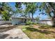 The home features a great backyard with mature trees, a patio, and a privacy fence at 6703 N Boulevard, Tampa, FL 33604