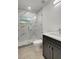 Bathroom featuring a tiled stand up shower with glass door and vanity at 6703 N Boulevard, Tampa, FL 33604