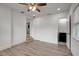 A bright bedroom with wood-look flooring and a ceiling fan with a full ensuite bathroom at 6703 N Boulevard, Tampa, FL 33604