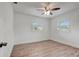 The bedroom has wood-look flooring, two windows and white paint at 6703 N Boulevard, Tampa, FL 33604
