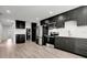 Modern kitchen with stainless steel appliances, dark cabinetry and a light wood floor at 6703 N Boulevard, Tampa, FL 33604
