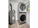 Laundry room features stacked washer and dryer next to the water heater by the window at 6703 N Boulevard, Tampa, FL 33604