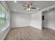 Bright living room with wood-look floors, recessed lighting, and a ceiling fan at 6703 N Boulevard, Tampa, FL 33604