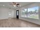 Bright living room with wood-look floors, recessed lighting, and a large window at 6703 N Boulevard, Tampa, FL 33604
