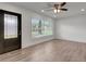 Bright living room with wood-look floors, recessed lighting, and a front door at 6703 N Boulevard, Tampa, FL 33604