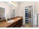 Bathroom featuring double sinks, granite countertops, and tiled floors at 7029 Dowling Mill Cir, Tampa, FL 33625