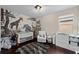 Charming Bedroom featuring a beautiful mural, crib, and lots of natural light at 7029 Dowling Mill Cir, Tampa, FL 33625