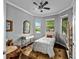 Cozy bedroom featuring dark wood floors, a ceiling fan, and lots of natural light at 7029 Dowling Mill Cir, Tampa, FL 33625