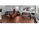 Bonus room with dark wood floors, foosball table, comfortable seating and decor at 7029 Dowling Mill Cir, Tampa, FL 33625
